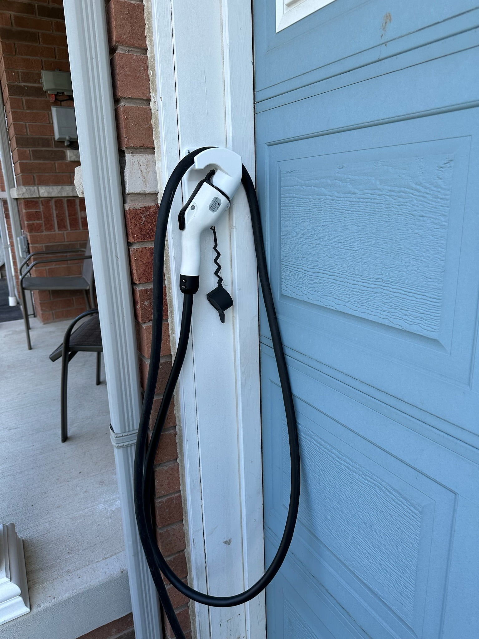 EV Charge Holster on a Garage Door